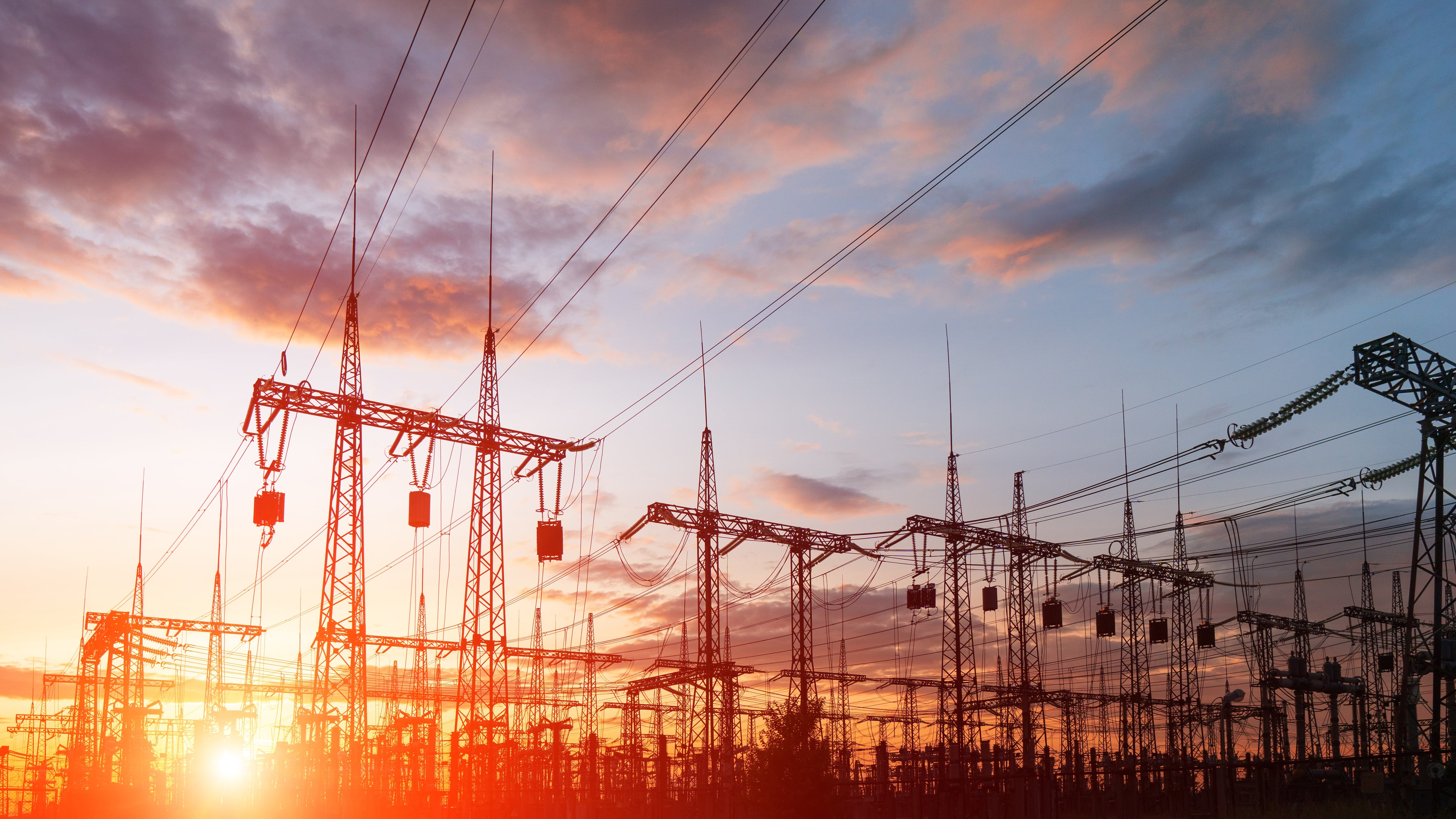 Silhouette High voltage electric tower on sunset time and sky on sunset time background