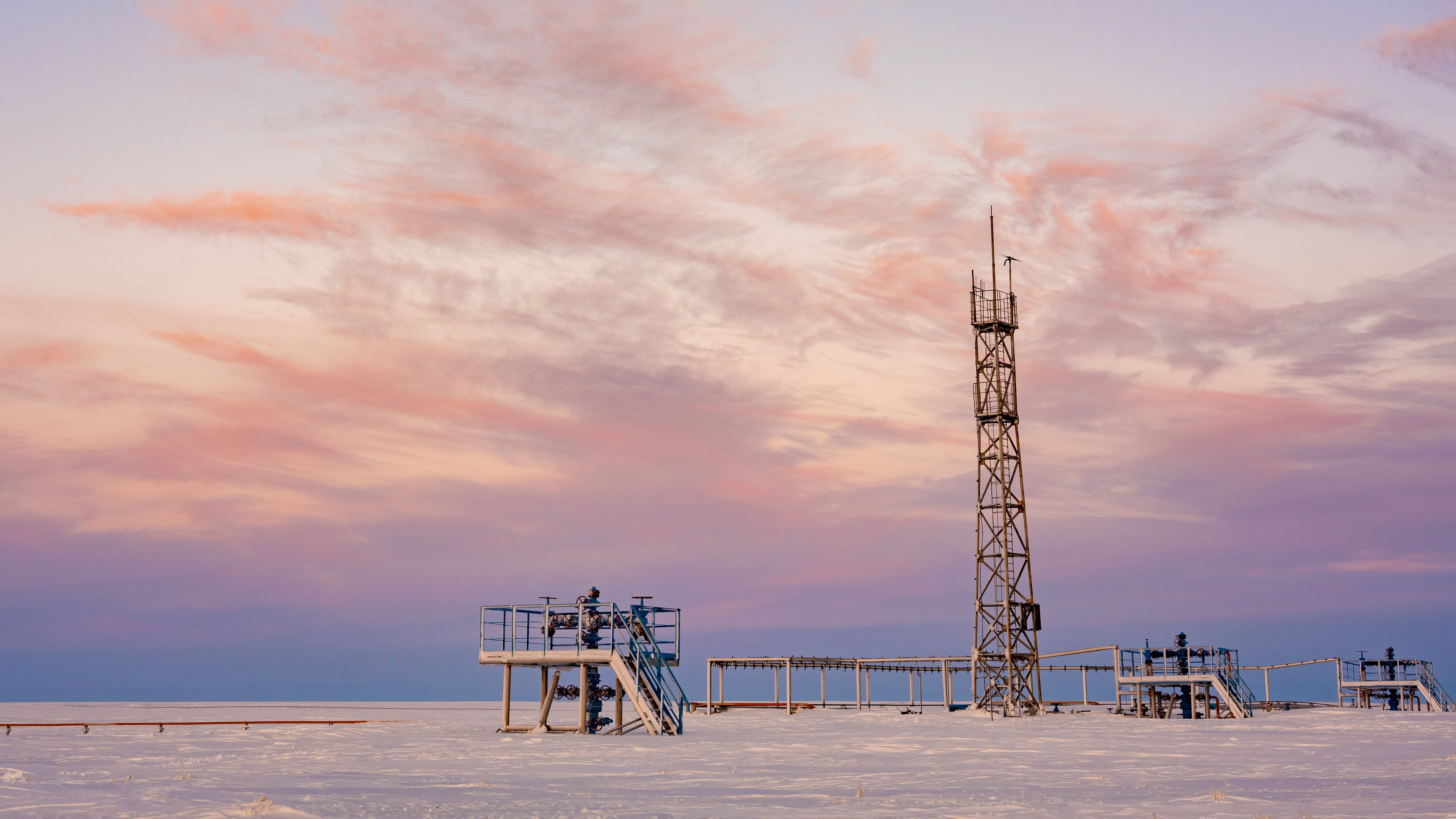 Oil, gas industry. The group of wellheads and valves on the background of snow tundra